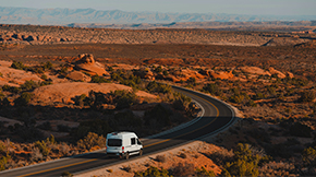 Campervan driving through desert