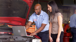 Woman receiving help at an Approved Auto Repair shop. 