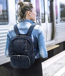 Woman with backpack boarding a train