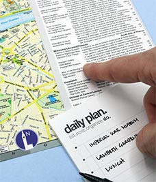 Person making their daily plan with a map and itinerary.