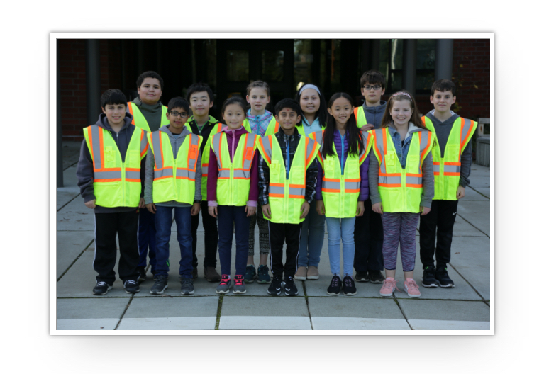 A group of safety patrol students in bright vests.