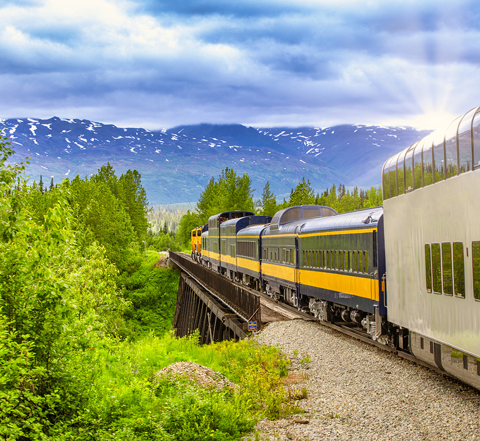 A train traveling toward mountains