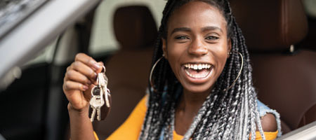 Woman smiling while holding keys